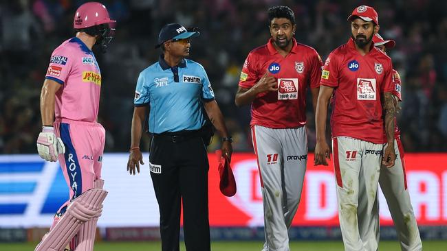 Rajasthan Royals' Jos Buttler, left, exchanges words with Kings XI Punjab's Ravi Ashwin. Picture: AFP