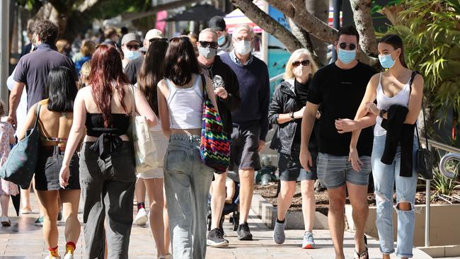 Holiday-makers mask up on Hastings Street in Noosa as parts of Queensland prepare to enter a snap three-day lockdown. Picture: Lachie Millard