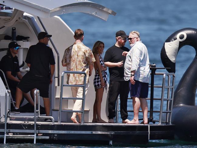 Kyle Sandilands has a cigarette on the back of the yacht with wife Tegan Kynaston. Picture: Sam Ruttyn