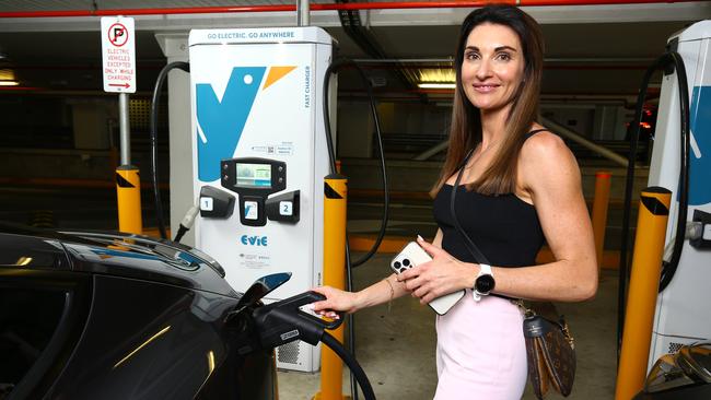 EV driver Michelle Ryan, Director of Bespoke Money Mortgage Broking, charging her vehicle at the Evie Network Charging station inside Indooroopilly shopping centre. Photo: David Clark