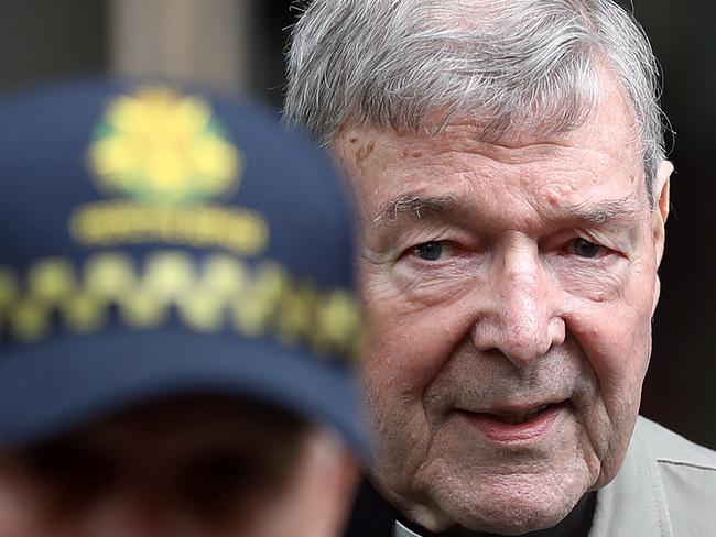 (FILES) This file photo taken on February 26, 2019 shows Cardinal George Pell (R) leaving the County Court of Victoria court in Melbourne. - Australian Cardinal George Pell will return to Rome on September 29, 2020 for the first time since being acquitted of child sexual abuse charges, and just days after a Vatican rival was ousted. (Photo by Con CHRONIS / AFP)