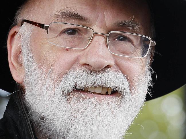 FILE - This is a Tuesday, Oct. 5, 2010 file photo of British author Terry Pratchett seen at the Conservative party conference in Birmingham, England. Fantasy writer Pratchett, creator of the “Discworld” series died Thursday March 12, 2015 aged 66. Pratchett, who suffered from a very rare form of early onset Alzheimer's disease, had earned wide respect throughout Britain with his dignified campaign for the right of critically ill patients to choose assisted suicide. (AP Photo/Kirsty Wigglesworth, File)