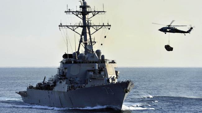 An SH-60B Sea Hawk helicopter approaches USS Decatur (DDG 73) during military exercises. Picture: Getty Images.