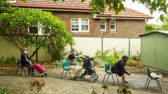 People ‘social distance’ in a queue for the Parish Pantry at St Paul's Anglican Church in Burwood. The pantry provides food for the vulnerable twice a week. Picture: Jenny Evans/Getty