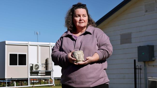 Eugowra resident Therese Townsend 52, outside her home that was hit by the floods last November and is now living in a transportable pod in her backyard with husband Jim and their son. Picture: Toby Zerna