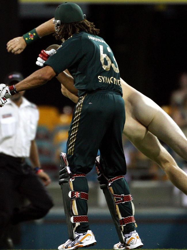 Andrew Symonds sends a streaker flying with a shoulder barge.