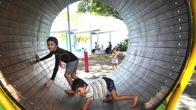 Brothers Jonty and Alby Rungan stay cool, playing in the shade at Muddy's Playground. Photo: Catherine Duffy