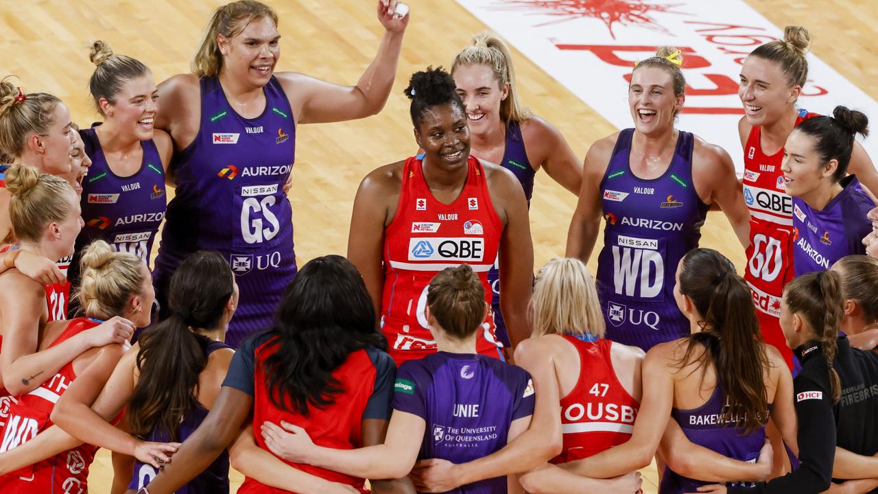 Players from The Swifts and Firebirds form a circle to celebrate 200th game played by Romelda Aiken George. Picture: Getty