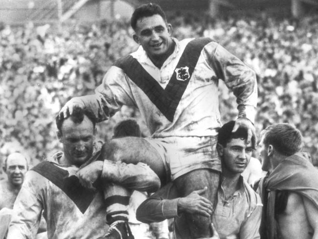 Captain-coach Ian Walsh is chaired off field by teammates Kevin Ryan and Johnny King after St George defeated Balmain in 1966 to record their 11th straight premiership win.