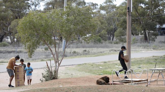 A family brings in emergency food parcels in Wilcannia, western NSW, over the weekend. Picture: Chris Pavlich