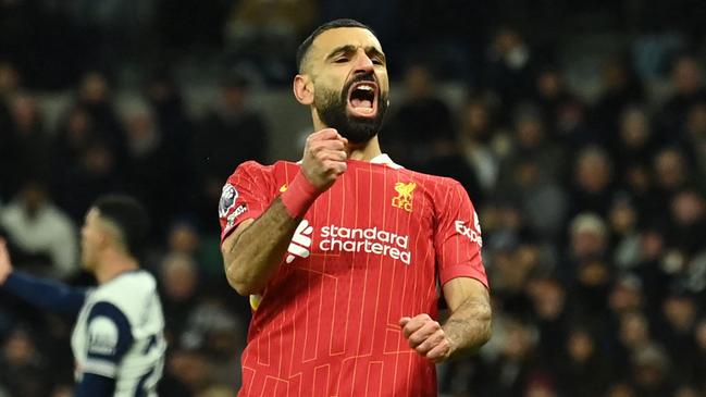 Liverpool's Egyptian striker #11 Mohamed Salah celebrates after scoring their fourth goal during the English Premier League football match between Tottenham Hotspur and Liverpool at the Tottenham Hotspur Stadium in London, on December 22, 2024. (Photo by Glyn KIRK / AFP) / RESTRICTED TO EDITORIAL USE. No use with unauthorized audio, video, data, fixture lists, club/league logos or 'live' services. Online in-match use limited to 120 images. An additional 40 images may be used in extra time. No video emulation. Social media in-match use limited to 120 images. An additional 40 images may be used in extra time. No use in betting publications, games or single club/league/player publications. /