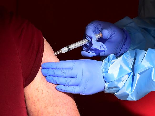 (FILES) In this file photo a senior citizen receives a COVID-19 vaccine at the Corona High School gymnasium in the Riverside County city of Corona, California on January 15, 2021, a day after California began offering the coronavirus vaccine to residents 65 and older. - Google said on January 25, 2021 it would make its facilities available for Covid-19 vaccination sites as part of a new initiative to help speed the rollout of inoculations in the United States. Chief executive Sundar Pichai made the announcement as part of a $150 million initiative to promote vaccine education and equitable access. (Photo by Frederic J. BROWN / AFP)