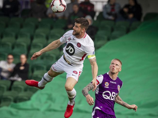 Brendan Hamill of the Wanderers leaps to head the ball.