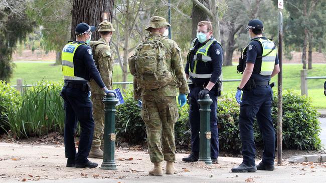 Police and the ADF made their presence felt today, enforcing face mask laws around the Royal Botanical Gardens. Picture: Matrix Media Group