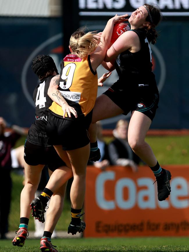 Megan Girolami takes a contested mark. Picture: Hamish Blair