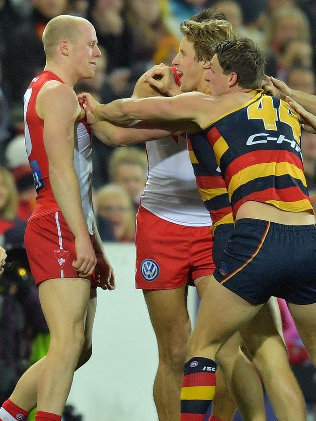 Adelaide players remonstrate with Zak Jones.