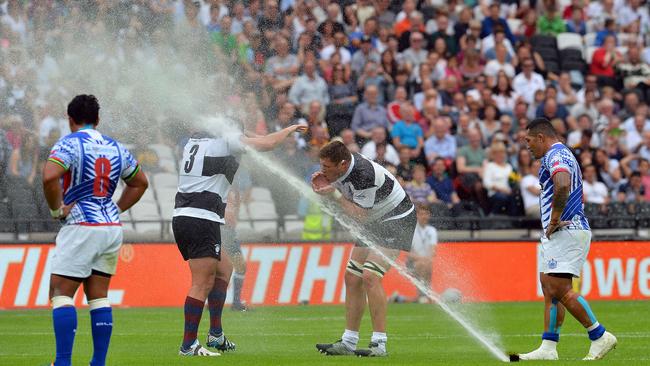 Barbarians lock Bakkies Botha takes a drink from a sprinkler which came on unexpectedly.