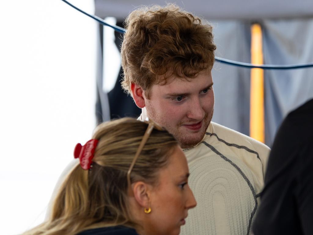 Autistic race car driver Ben Taylor reviews his performance with his team after the Porsche Michelin Sprint Challenge. Picture: supplied