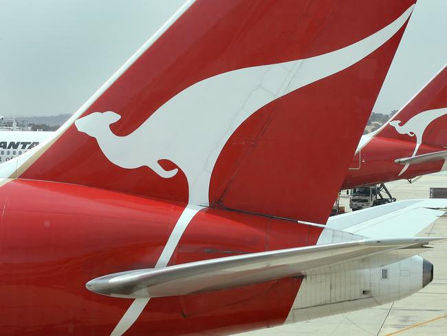 Qantas planes sit at their gates at Melbourne's Tullamarine Airport as the Qantas accepted an offer, 14 Dec 2006, to sell to a private equity group : AFP PicWilliam/West - industry aviation airlines aircraft plane logo logos flying kangaroo on tail companies