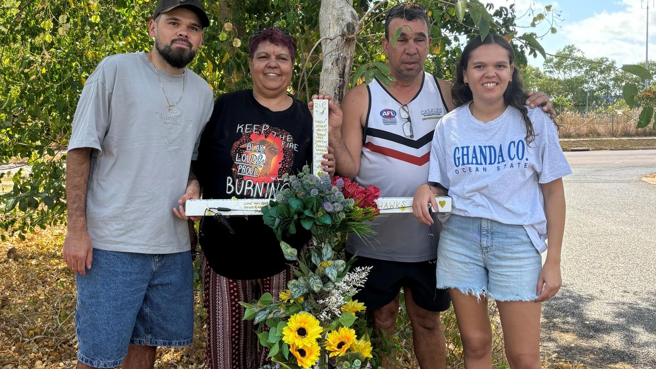 Vicki Hayes (centre) with her brother Steven, nephew Damien, and niece Kitisha at the Nightcliff Rd and Clematis St memorial to her brother Wayne. Picture: Supplied