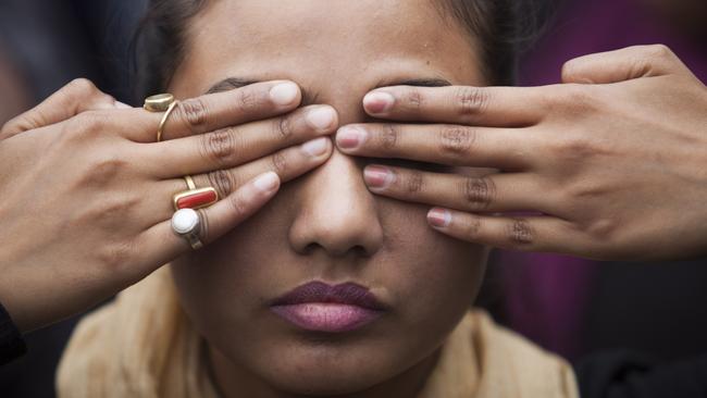 An Indian girl participates in a street play to create awareness on violence against women during a protest ahead of the second anniversary of the deadly gang rape of a 23-year-old physiotherapy student on a bus, in New Delhi, India, Monday, Dec. 15, 2014. The case sparked public outrage and helped make women’s safety a common topic of conversation in a country where rape is often viewed as a woman’s personal shame to bear. (AP Photo/Tsering Topgyal)