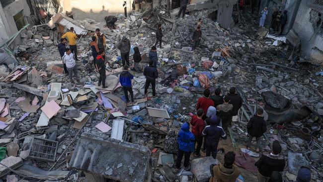 People gather amid the destruction following an early-morning Israeli strike in Rafah in the southern Gaza Strip on Saturday. Picture: AFP