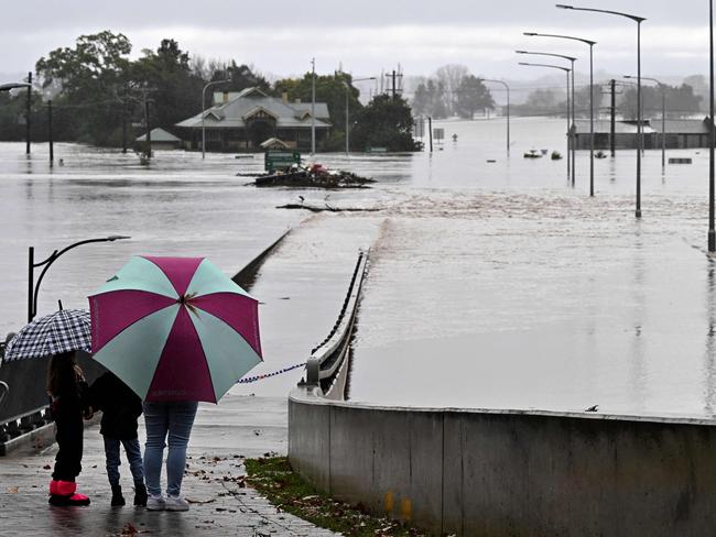 The old Windsor Bridge was submerged — again — by the overflowing Hawkesbury River on July 4. Picture: AFP