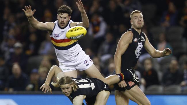 Mitch McGovern of the Crows flies for a mark over Carlton rookies Tom De Koning and Harry McKay on Saturday night. Will it be his last game in Adelaide colours? Picture: AAP Image/Daniel Pockett