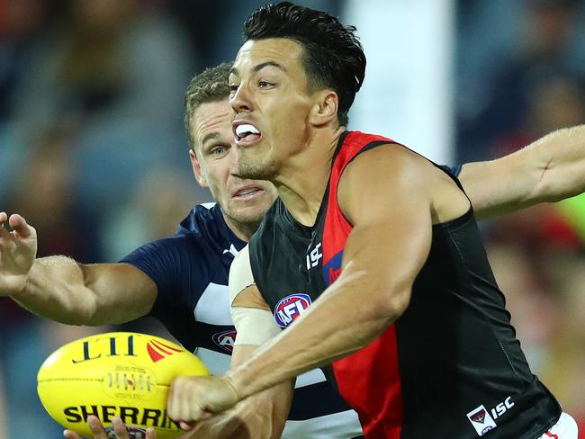 GEELONG, AUSTRALIA - MARCH 07: Dylan Shiel of the Bombers is chased by Joel Selwood of the Cats during the 2019 JLT Community Series AFL match between the Geelong Cats and the Essendon Bombers at GMHBA Stadium on March 07, 2019 in Geelong, Australia. (Photo by Scott Barbour/Getty Images)