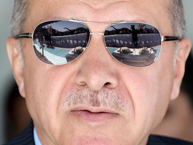 The silhouette of the crowd is reflected on the sunglasses of Turkish President Recep Tayyip Erdogan during the opening ceremony of the Wonderland Eurasia theme park in Ankara on March 20, 2019. (Photo by Adem ALTAN / AFP)