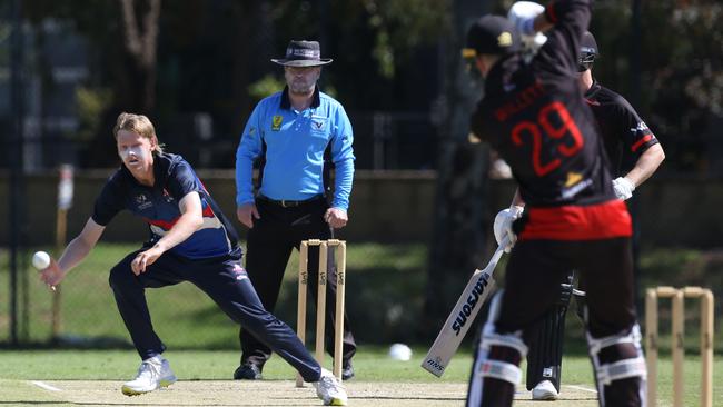 Premier: Footscray’s Max Birthisel fields off his bowling. Picture: Stuart Milligan