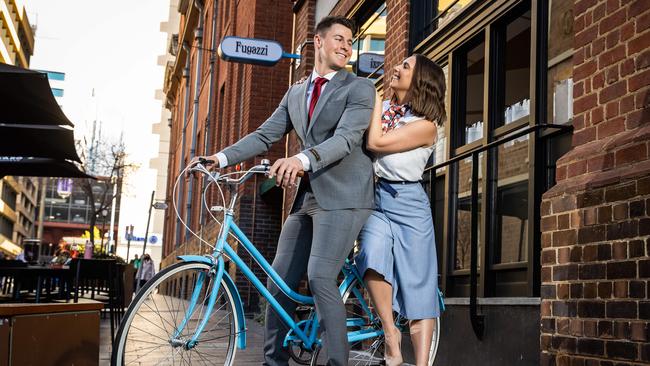 Fugazzi Bar and Dining Room owners Max and Laura Sharrad, dressed by David Jones and Dulcie’s Bus respectively, outside the restaurant in Leigh St. Picture: Tom Huntley