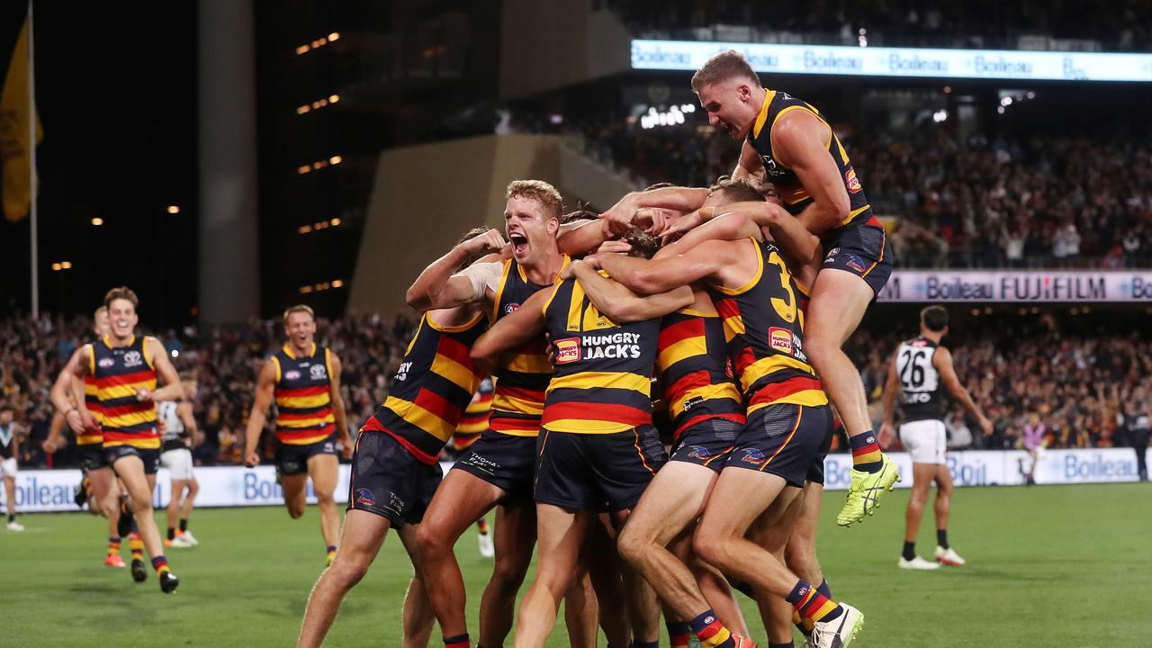 Players swamp Dawson after he came up clutch. Picture: Getty Images