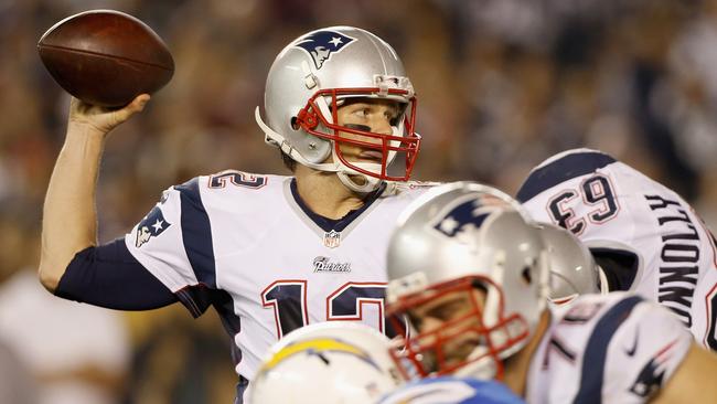 Quarterback Tom Brady #12 of the New England Patriots looks to pass against the San Diego Charger defence.