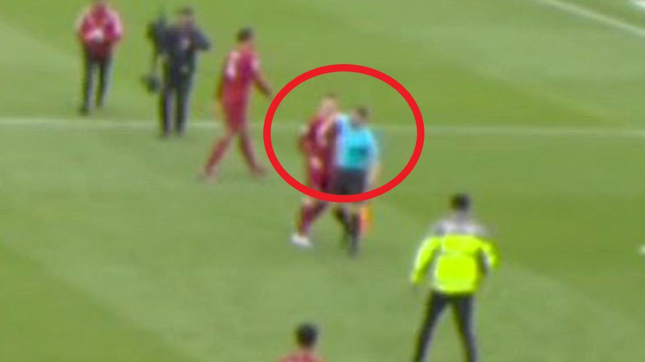 Andy Robertson is elbowed by the assistant referee.