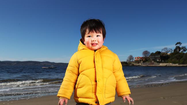 Finn Kou 2 1/2 of Hobart at Long Beach Sandy Bay. Warmer Winter weather is on the way for Hobart with a top of 17 expected during the week ahead. Picture: Nikki Davis-Jones