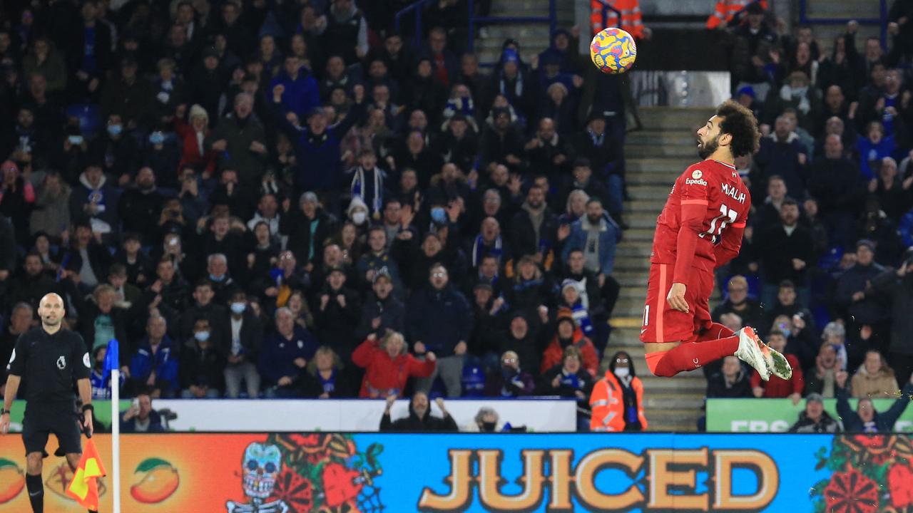 Liverpool's Egyptian midfielder Mohamed Salah jumps to header the ball after it rebounded from his penalty shot, saved by Leicester City's Danish goalkeeper Kasper Schmeichel (unseen), but failed to score during the English Premier League football match between Leicester City and Liverpool at King Power Stadium in Leicester, central England on December 28, 2021. (Photo by Lindsey Parnaby / AFP) / RESTRICTED TO EDITORIAL USE. No use with unauthorized audio, video, data, fixture lists, club/league logos or 'live' services. Online in-match use limited to 120 images. An additional 40 images may be used in extra time. No video emulation. Social media in-match use limited to 120 images. An additional 40 images may be used in extra time. No use in betting publications, games or single club/league/player publications. /