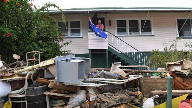 Debris piled in front of Ruth Feltham's Murwillumbah home in early April last year. The record 2022 floods spread waste far and wide. Picture: AAP Image/Tracey Nearmy