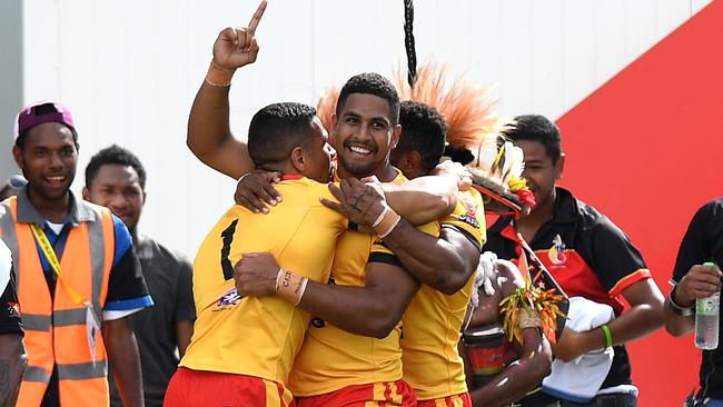 Papua New Guinea players congratulate David Mead on a try.