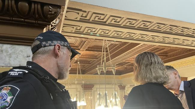 A policeman escorts a protester from the Chamber.
