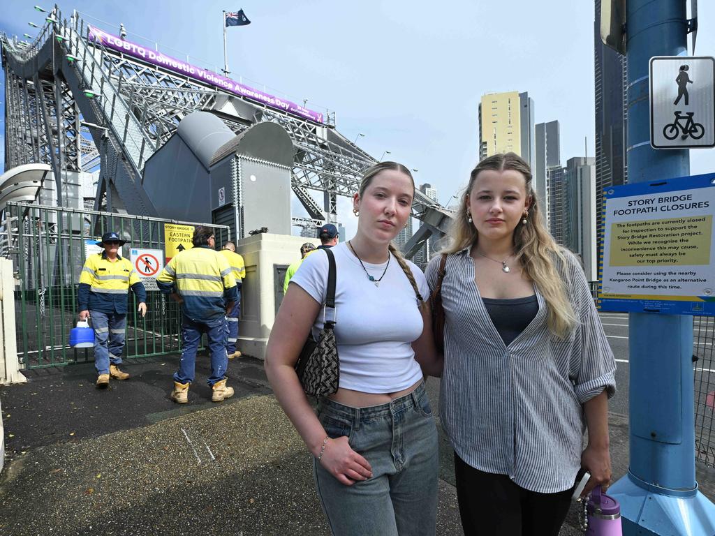 Disappointed tourists Katy Smith and Neve Waller were hoping to cross the Story Bridge on their last day in Brisbane this week. Walkways are closed to pedestrians. Picture: Lyndon Mechielsen