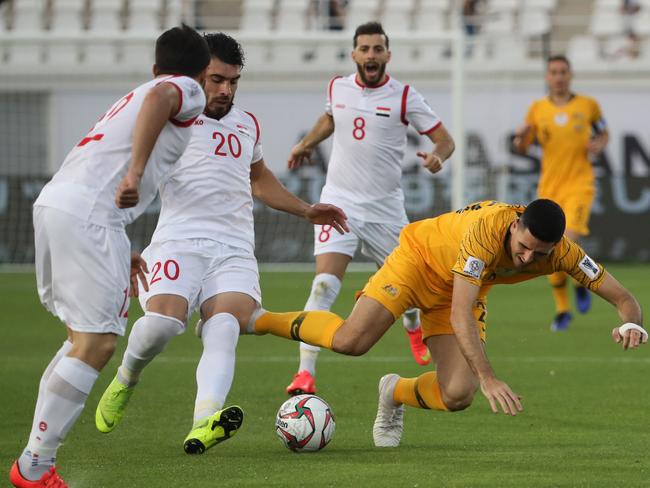 Syria's midfielder Khaled Al Mbayed fights for the ball against Australia's Tom Rogic at the 2019 Asian Cup.