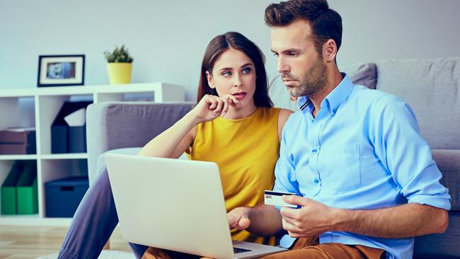 A couple who are stressed about money working out their finances together and assessing their credit card debt. Picture: iStock.