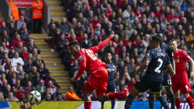 Liverpool's Daniel Sturridge, center, scores against Southampton during their English Premier League soccer match at Anfield Stadium, Liverpool, England, Sunday Aug. 17, 2014. (AP Photo/Jon Super)