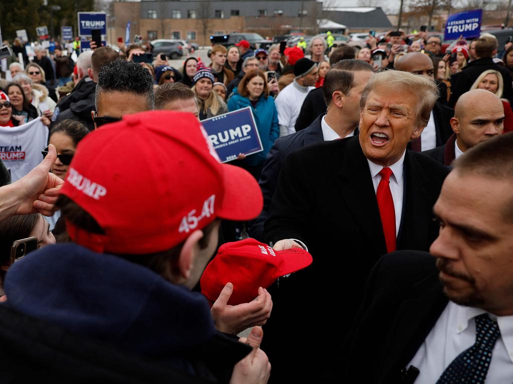 The former US president is cheered on by supporters at the polling station. Picture: Getty Images