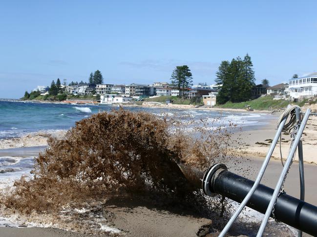 Wyong Council is pumping sand from The Entrance Channel into the surf zone, on The Entrance Beach, to address erosion. Picture: Peter Clark