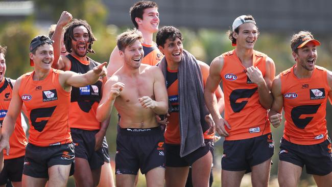 Toby Greene and Giants players watch a staff sprint race. Picture: Phil Hillyard