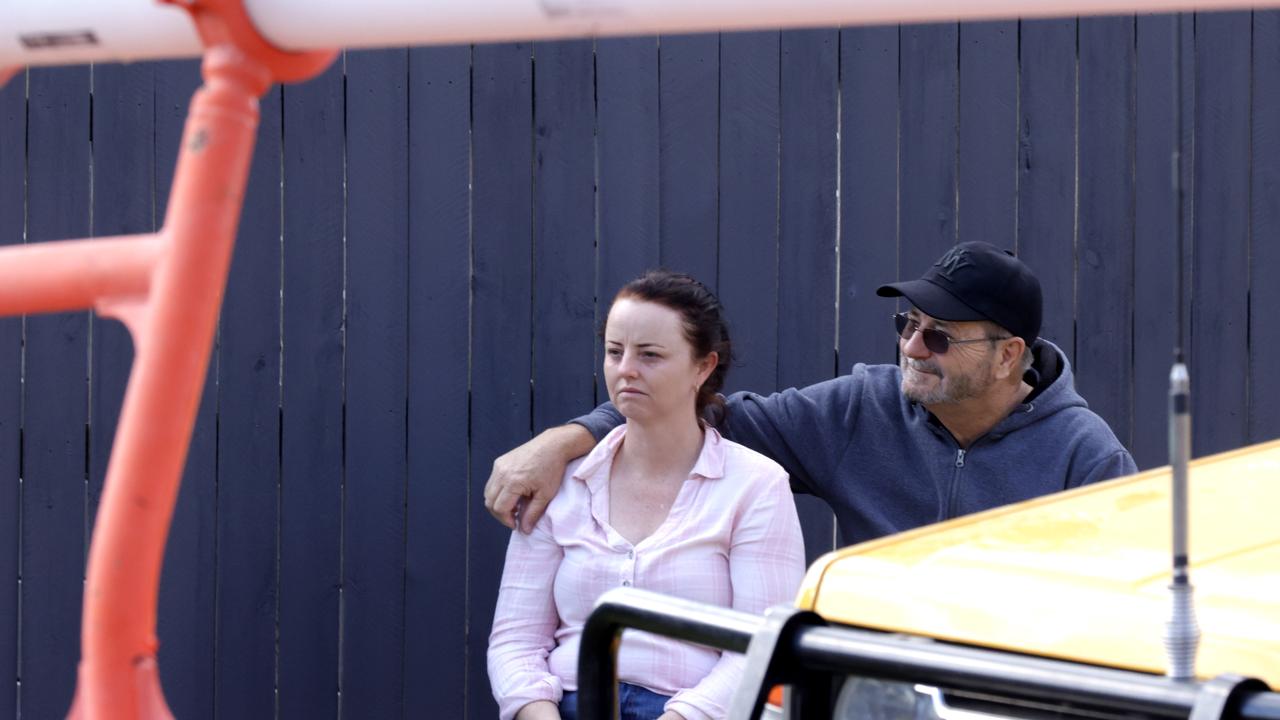 Homeowner Melinda Stuart is supported by family after construction equipment crashed through her home in Deebing Heights. Picture: Steve Pohlner