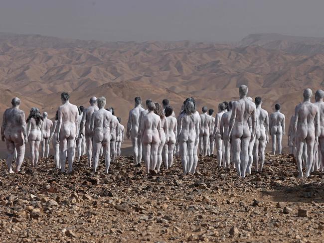 Participants pose nude for American art photographer Spencer Tunick, working on a photo installation in the desert landscape surrounding the southeastern Israeli city of Arad, some 15 kilometre west of the Dead Sea, on October 17, 2021. - About 300 participants have registered to be part of the nude photo installation, designed to draw world attention to the importance of preserving and restoring the Dead Sea, a unique natural resource and one of Israelâs most famous tourist attractions. (Photo by Menahem KAHANA / AFP) / RESTRICTED TO EDITORIAL USE - MANDATORY MENTION OF THE ARTIST UPON PUBLICATION - TO ILLUSTRATE THE EVENT AS SPECIFIED IN THE CAPTION- NO MARKETING NO ADVERTISING CAMPAIGNS - DISTRIBUTED AS A SERVICE TO CLIENTS