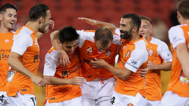 Brisbane Roar’s Avraam Papadopoulos (centre with head down) celebrates scoring against Melbourne City on Friday night.